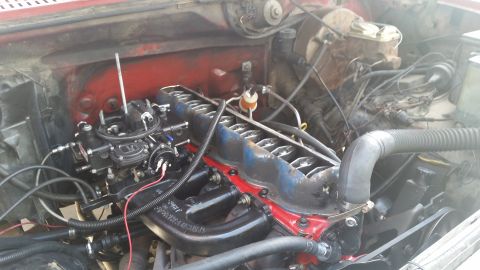 1981 Ford Bronco - Close-up view of an engine bay, focusing on the carburetor and intake manifold components.