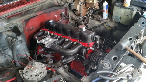1981 Ford Bronco - The engine bay shows a red engine block with a black intake manifold and various hoses and wires. The Supermotors.net logo is visible in th…