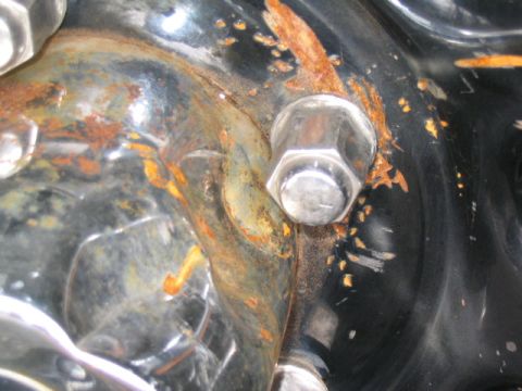 1996 Ford F-150 - Detail of a corroded metal bracket and bolt, likely from a vehicle's undercarriage.