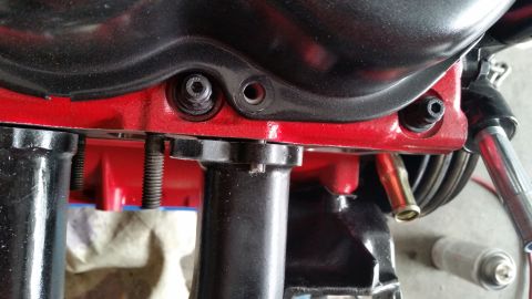1981 Ford Bronco - Detail of engine parts, including bolts and a brass fitting, with a watermark for Supermotors.net.