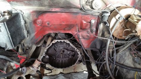 1981 Ford Bronco - Close-up view of a vehicle's engine bay, showing the transmission and firewall details.