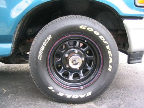 1996 Ford F-150 - A close-up view of a tire and wheel assembly on a vehicle.