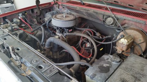 1981 Ford Bronco - Close-up view of a vehicle's engine compartment, showing various hoses, wires, and an aftermarket air filter.