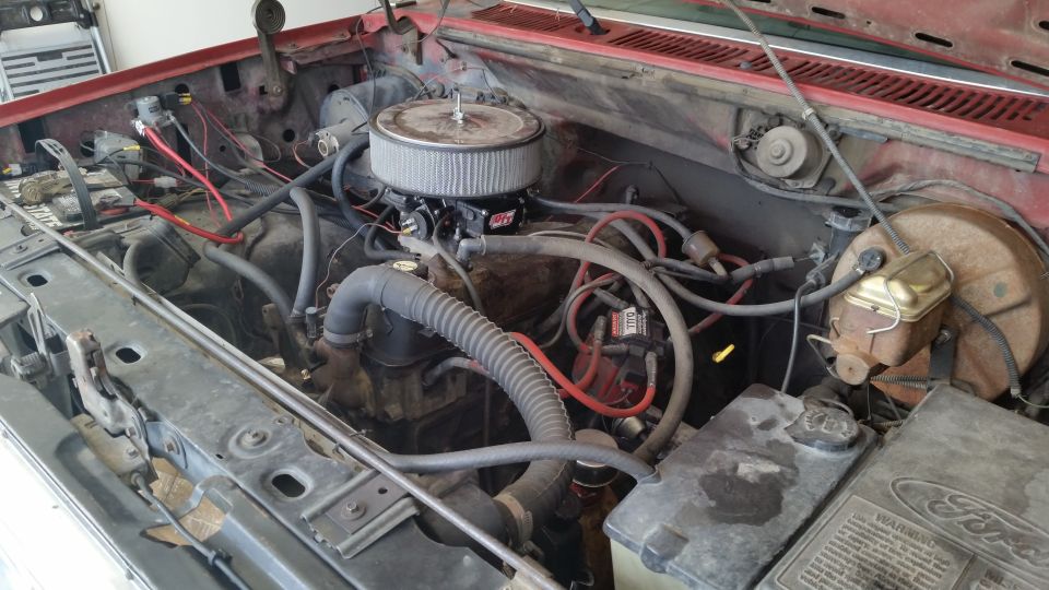 Engine bay with aftermarket air filter and visible wiring