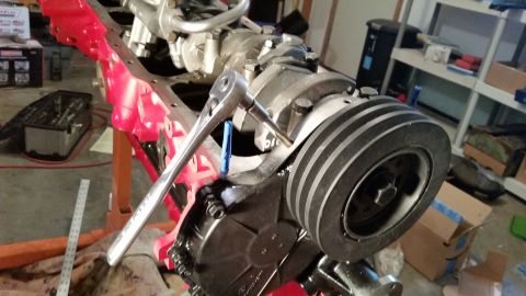 1981 Ford Bronco - Close-up of an engine block being worked on, with a socket wrench attached to a pulley system.