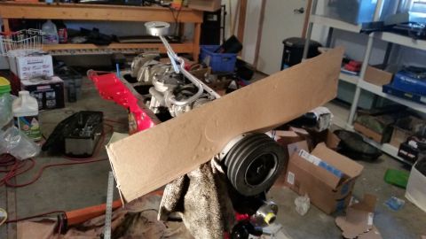 1981 Ford Bronco - Engine block in a garage with various tools and boxes scattered around.