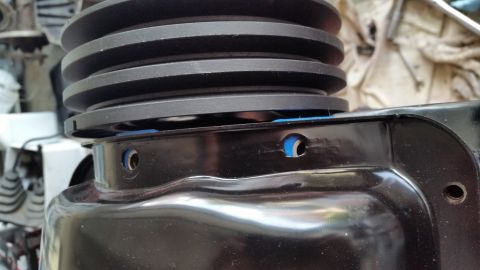 1981 Ford Bronco - A close-up view of a black pulley system, possibly from an engine bay, with visible blue accents.