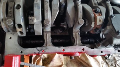 1981 Ford Bronco - Close-up view of an engine's crankshaft and connecting rods, showing various stamped markings.