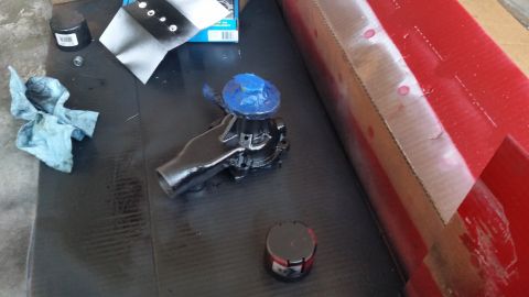 1981 Ford Bronco - A car water pump is shown on a workbench, ready for installation or repair.