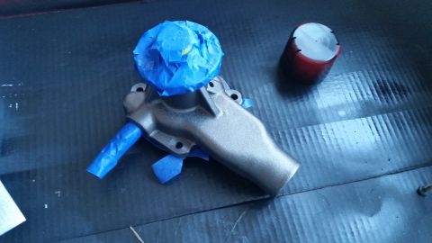 1981 Ford Bronco - Water pump part is masked with blue tape before painting or cleaning.