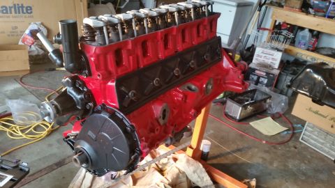 1981 Ford Bronco - A red V8 engine block is mounted on an engine stand, ready for assembly or installation.