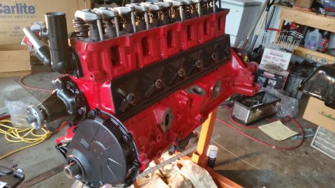 1981 Ford Bronco - A freshly painted red V8 engine sits on an engine stand, ready for installation or rebuild.