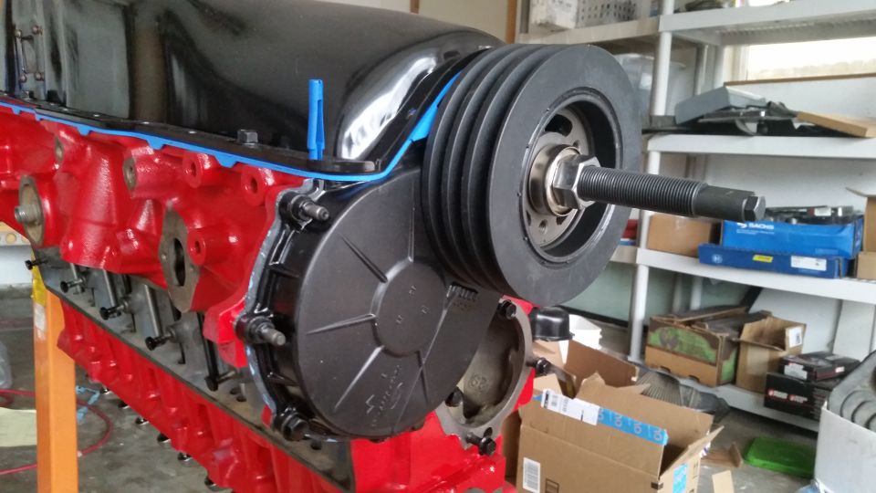 Red engine block with crankshaft pulley and timing cover