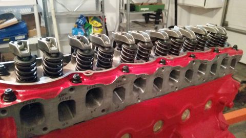 1981 Ford Bronco - Engine cylinder head with visible markings and valve train components, painted red.