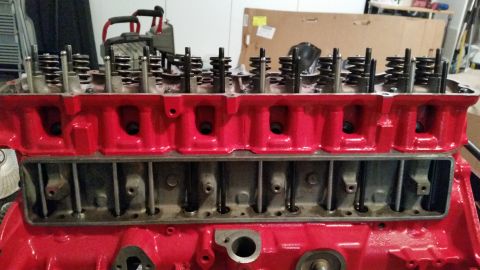 1981 Ford Bronco - Close-up of a red engine cylinder head, showing internal components and valve train.