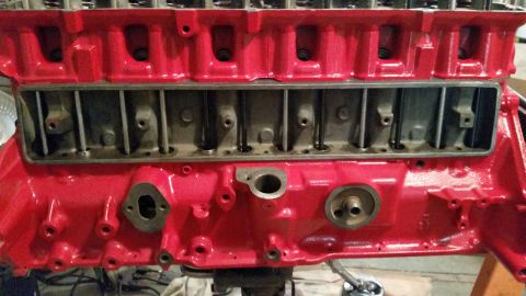 1981 Ford Bronco - Close-up view of a red engine block, showing internal components and mounting points.