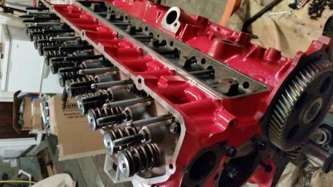 1981 Ford Bronco - Engine cylinder head assembly with valves and springs, a large gear on the side.