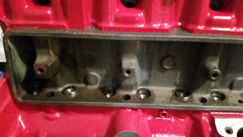 1981 Ford Bronco - Close-up view of a red engine block, showing internal components and bolt holes.