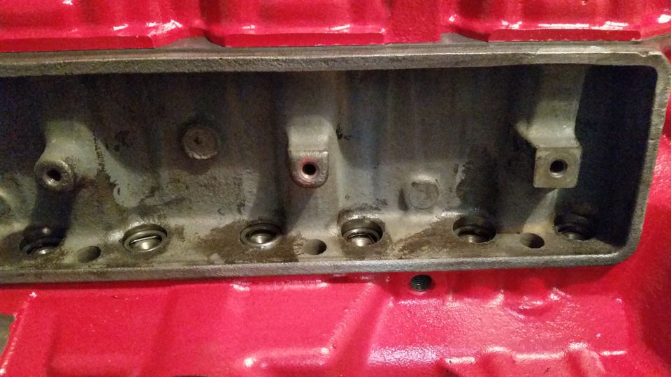 Red engine block with open intake manifold ports and valve springs
