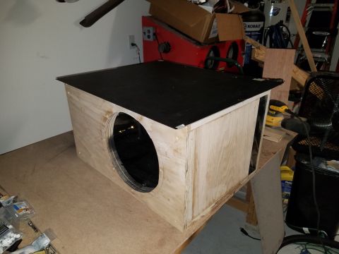 1994 Ford Bronco - A custom-built wooden subwoofer enclosure sits on a workbench, ready for installation.