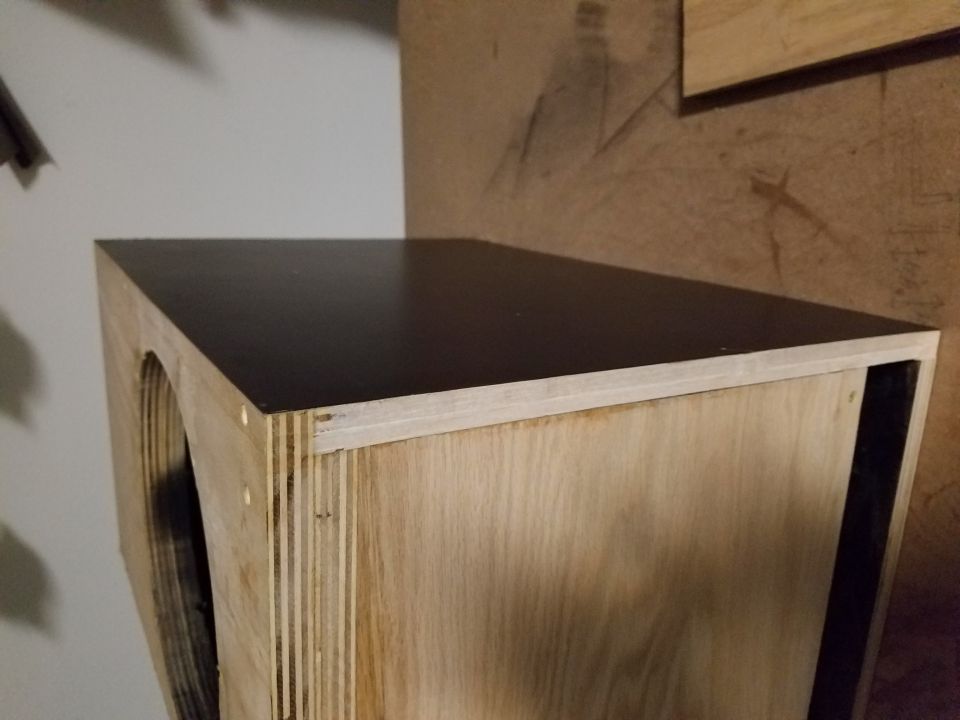Wooden box with a dark top, looks like a custom speaker enclosure