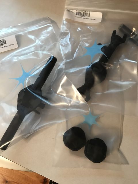 1989 Ford Bronco - Two plastic bags contain black automotive parts, with labels visible on each bag.