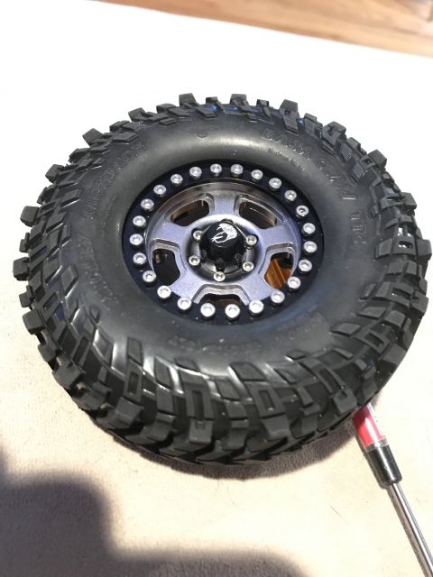 1989 Ford Bronco - Close-up of an off-road tire and wheel assembly, likely for an RC car or custom build.