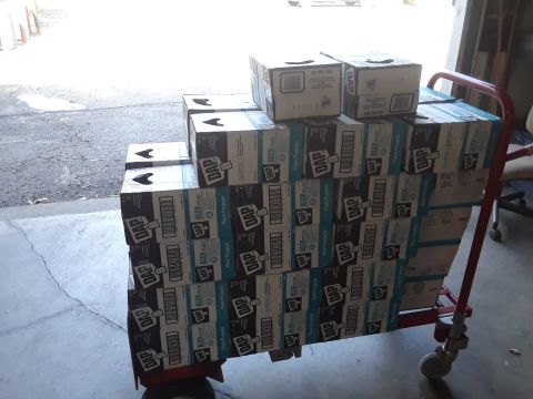 1994 Ford Bronco - A dolly is filled with numerous boxes of DAP Alex Plus caulk, ready for transport.