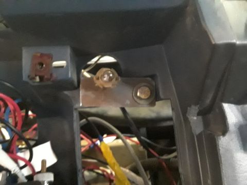 1985 Ford Bronco - Close-up view of exposed wiring and components within a vehicle's dashboard.