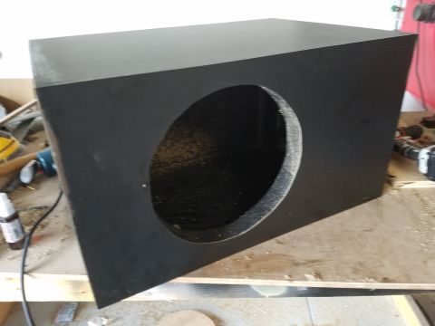 1994 Ford Bronco - Photograph of a black speaker enclosure with a circular woofer cutout, not a technical document.