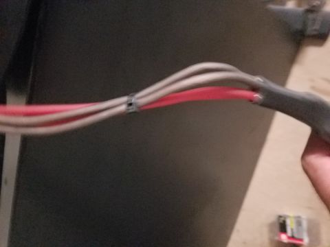 1994 Ford Bronco - Photograph of speaker wiring being held, not a technical document.