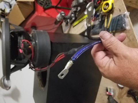 1994 Ford Bronco - Photograph of a terminated ground cable beside a speaker, not a technical document.