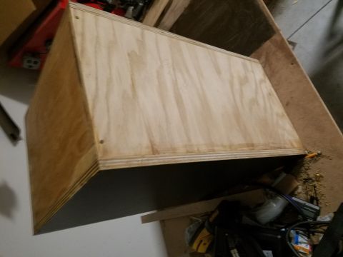 1994 Ford Bronco - Photograph of a raw plywood enclosure under construction, not a technical document.