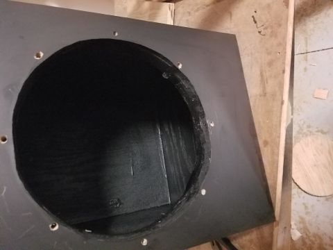 1994 Ford Bronco - Photograph looking into a speaker box through its woofer cutout, not a technical document.