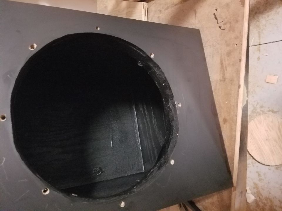 Photo of a speaker enclosure interior viewed through a round cutout