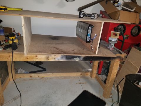 1994 Ford Bronco - Photograph of a speaker enclosure build with an amplifier on the bench, not a technical document.