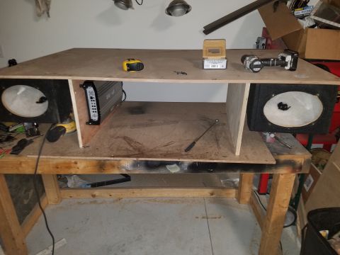1994 Ford Bronco - Photo of a custom plywood subwoofer box being built on a workbench, not a technical document.