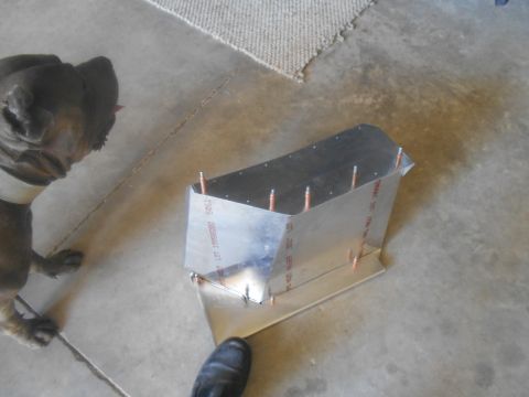 1992 Ford Bronco - A pit bull dog looks down at a metal fabrication project on a concrete floor.