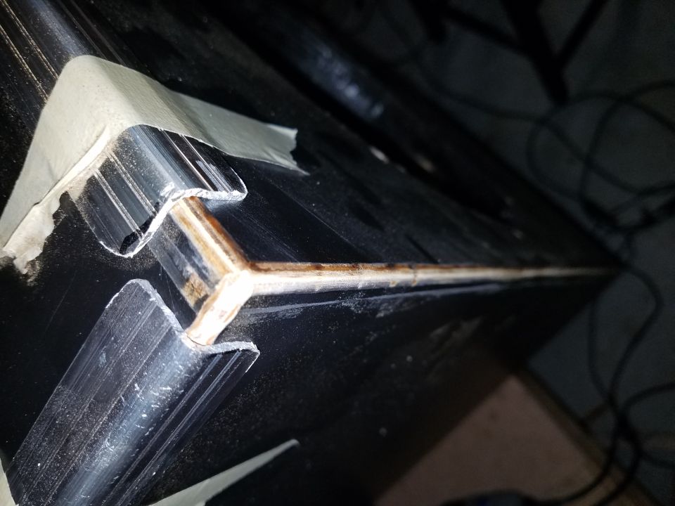 Close-up of an aluminum extrusion corner joint on a black road case