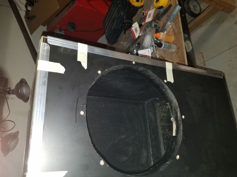 1994 Ford Bronco - Photo of a road-case panel with a round speaker cutout during fabrication, not a technical document.