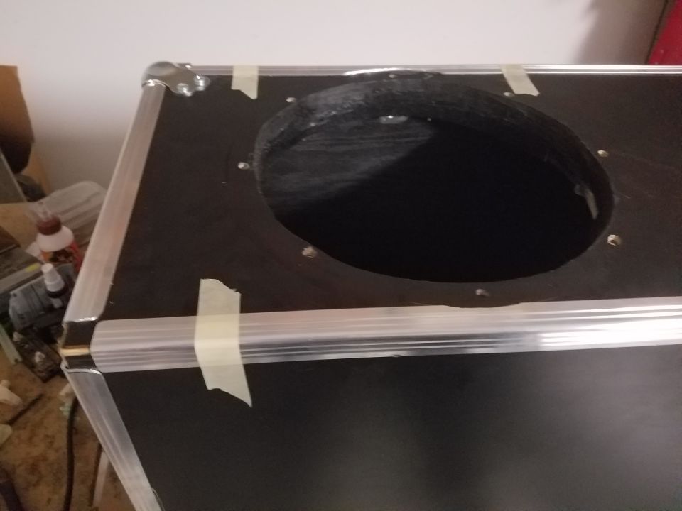 Close-up of a car stereo speaker mounted in a dashboard