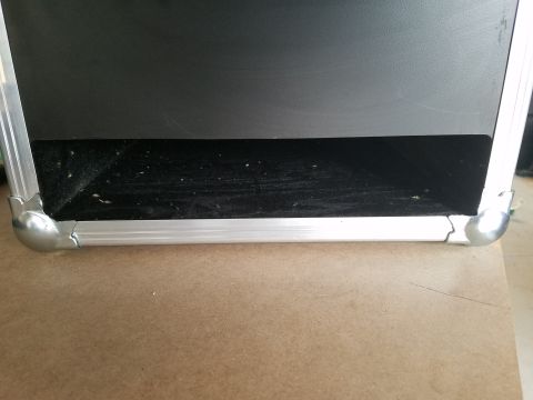 1994 Ford Bronco - Photo close-up of the bottom edge and aluminum corners of a road case, not a technical document.