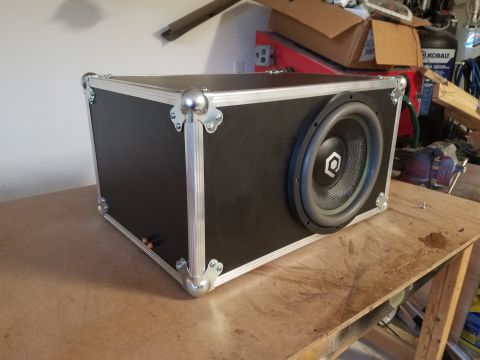 1994 Ford Bronco - Photo of a road-case subwoofer enclosure with a driver, not a technical document.