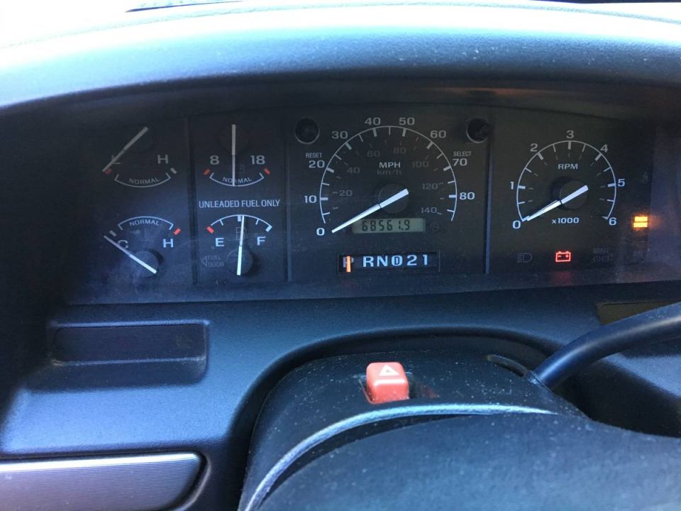 1994 Ford F-150 dashboard with illuminated warning lights and odometer reading 68561.9