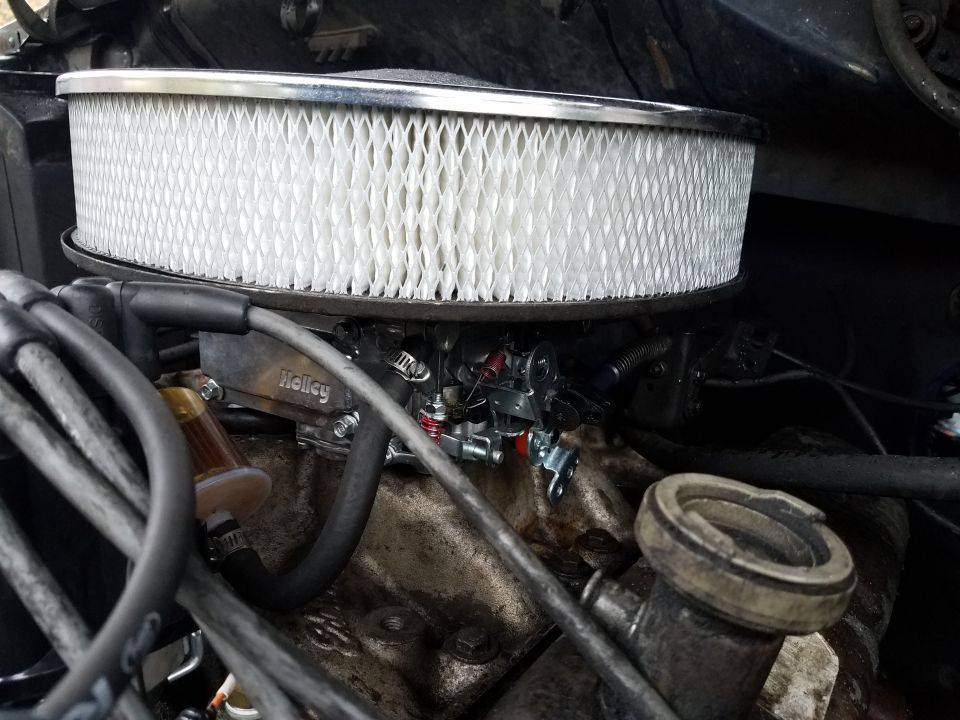 Holley carburetor and air filter on an engine.