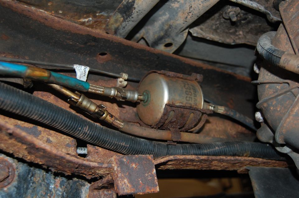 Rusty fuel filter and hoses on vehicle undercarriage