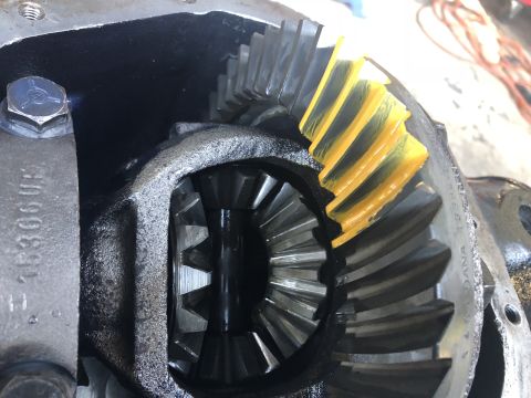 1995 Ford F-150 - A close-up view of the differential gears of a 1995 Ford F-150, showing the ring gear with yellow gear marking compound applied to its teet…