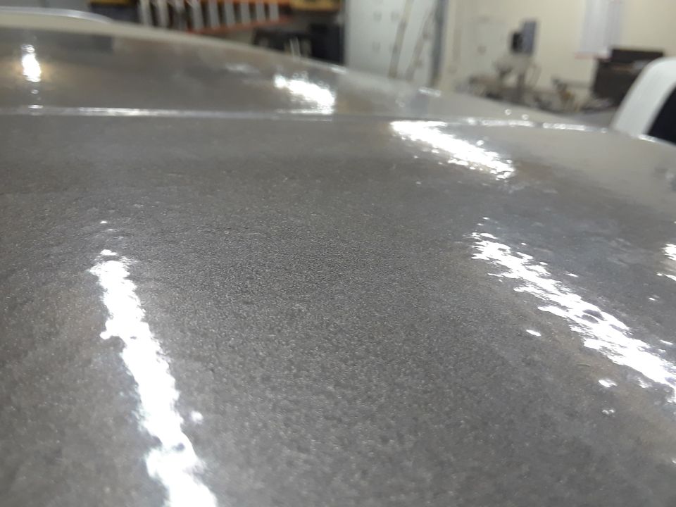 Close-up of metallic gray vehicle roof with reflections