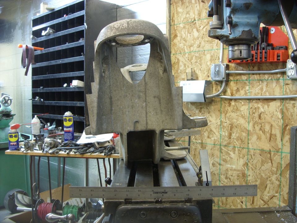 Large metal machine part on a workbench in a workshop.