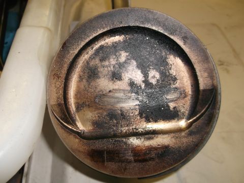 1970 Ford Torino - This is a close-up view of a piston, showing signs of wear and carbon deposits.